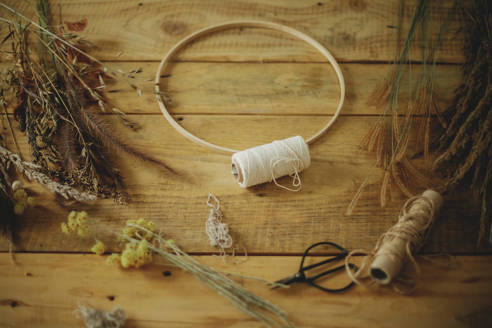 Workspace with threads, needles and embroidery hoop