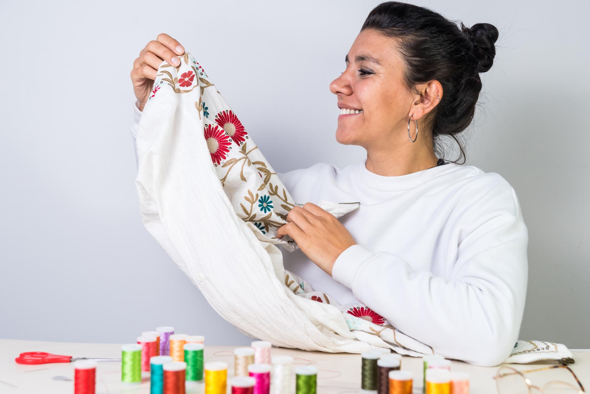 Instructor demonstrating embroidery stitch to students